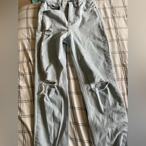 Light washed, high rise, button-fly, ripped jeans